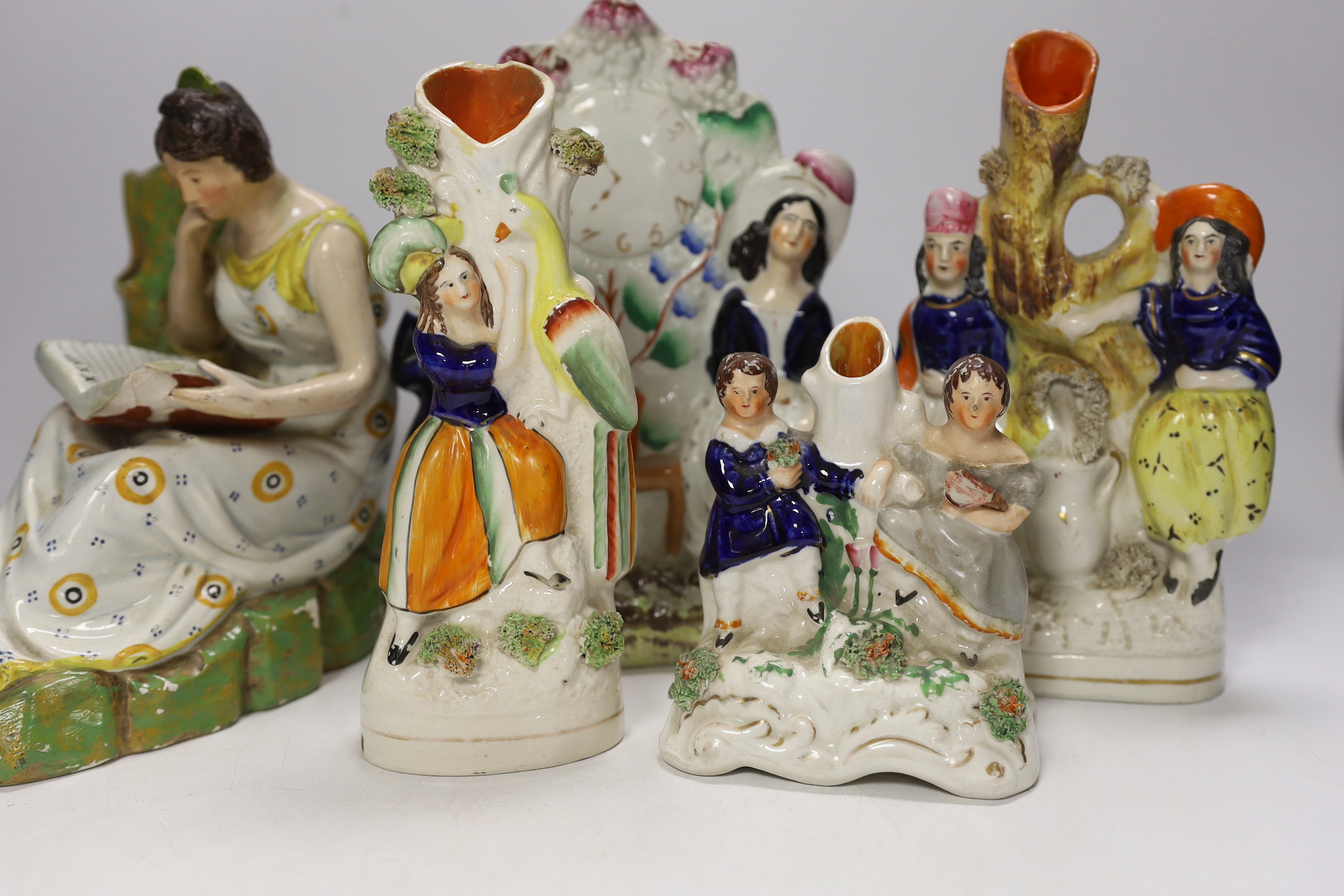An early 19th century Staffordshire pearlware figure of a seated lady and seven mid 19th century Staffordshire pottery figures
